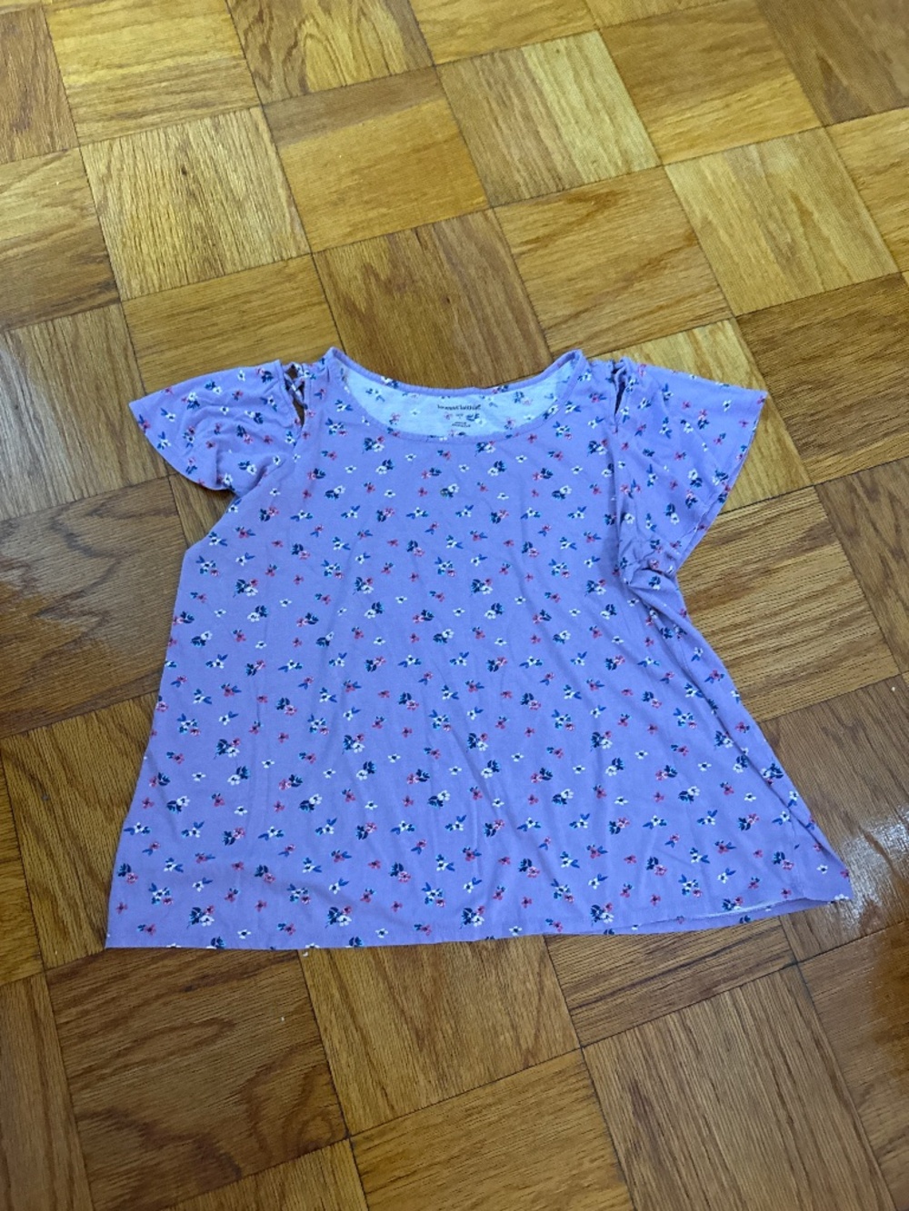 Woman With lavender shirt flutter sleeve with floral print, size large